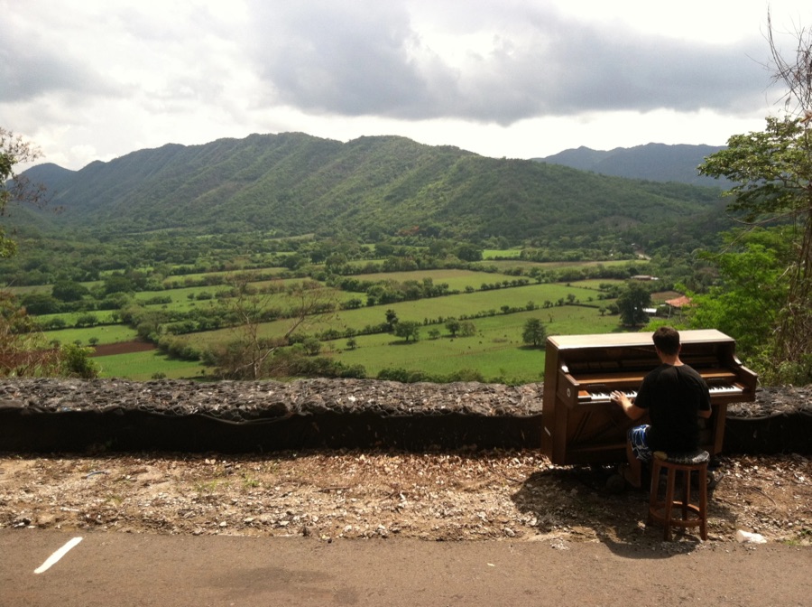 Playing the piano above a green valley in Central America